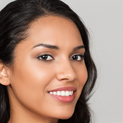 Joyful latino young-adult female with long  brown hair and brown eyes