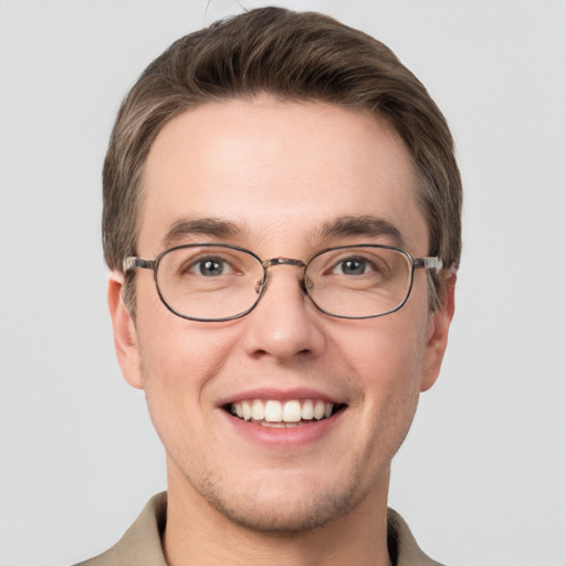 Joyful white young-adult male with short  brown hair and grey eyes