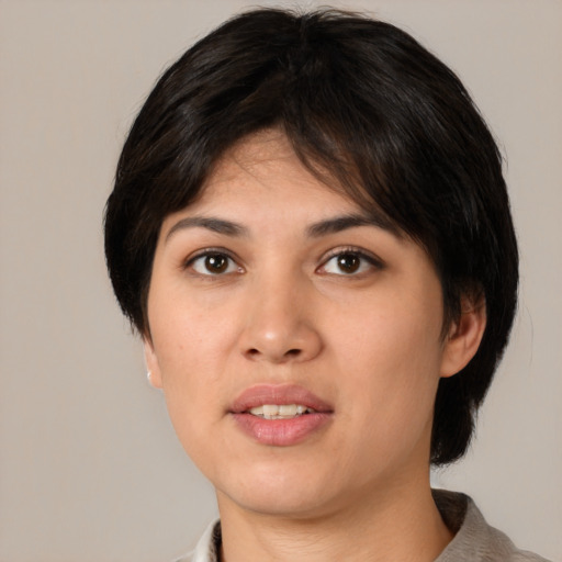 Joyful white young-adult female with medium  black hair and brown eyes