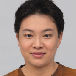 Joyful asian young-adult female with short  brown hair and brown eyes