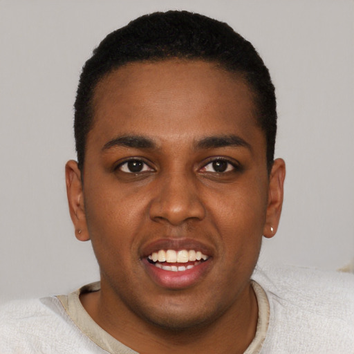 Joyful black young-adult male with short  black hair and brown eyes