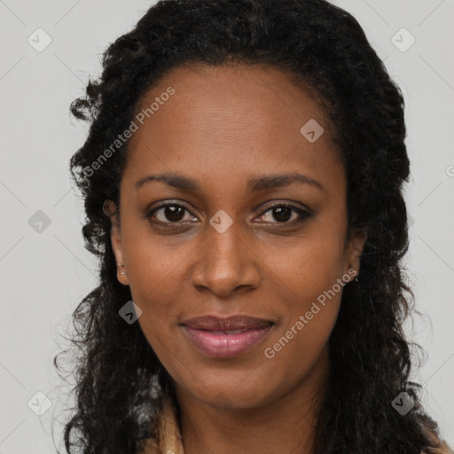 Joyful black young-adult female with long  brown hair and brown eyes