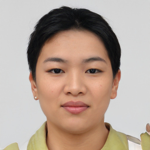 Joyful asian young-adult female with short  black hair and brown eyes
