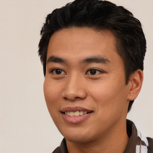 Joyful asian young-adult male with short  brown hair and brown eyes