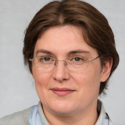 Joyful white adult female with medium  brown hair and blue eyes