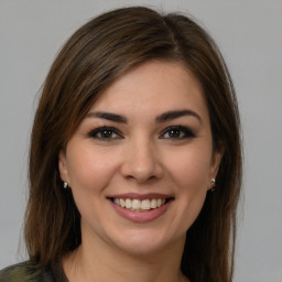 Joyful white young-adult female with medium  brown hair and brown eyes