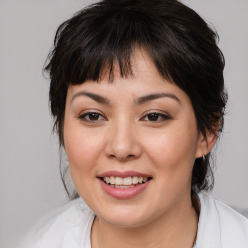Joyful asian young-adult female with medium  brown hair and brown eyes