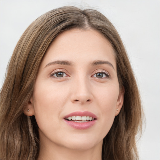 Joyful white young-adult female with long  brown hair and green eyes