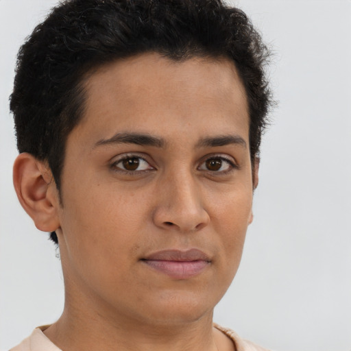 Joyful latino young-adult male with short  brown hair and brown eyes