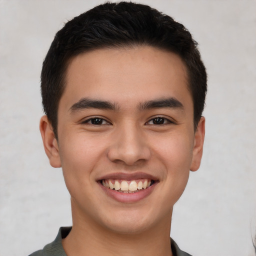 Joyful latino young-adult male with short  brown hair and brown eyes