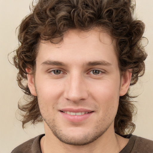 Joyful white young-adult male with medium  brown hair and brown eyes