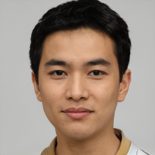 Joyful asian young-adult male with short  black hair and brown eyes