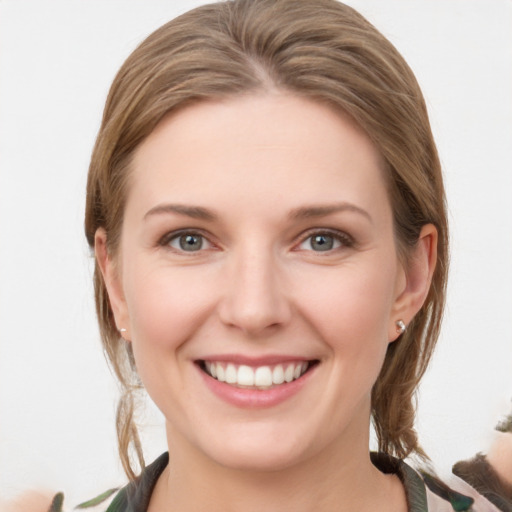 Joyful white young-adult female with medium  brown hair and grey eyes