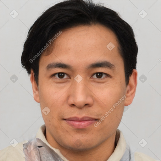 Joyful asian adult male with short  brown hair and brown eyes