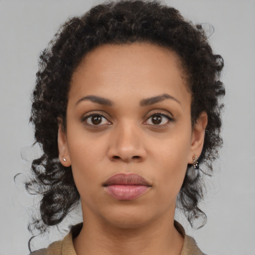 Joyful black young-adult female with medium  brown hair and brown eyes