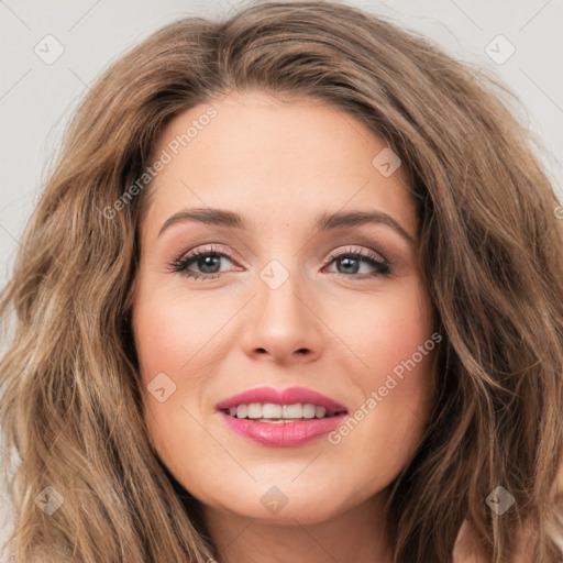 Joyful white young-adult female with long  brown hair and green eyes