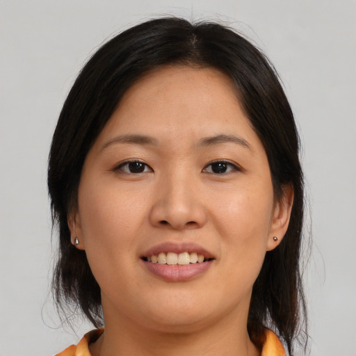 Joyful asian young-adult female with medium  brown hair and brown eyes