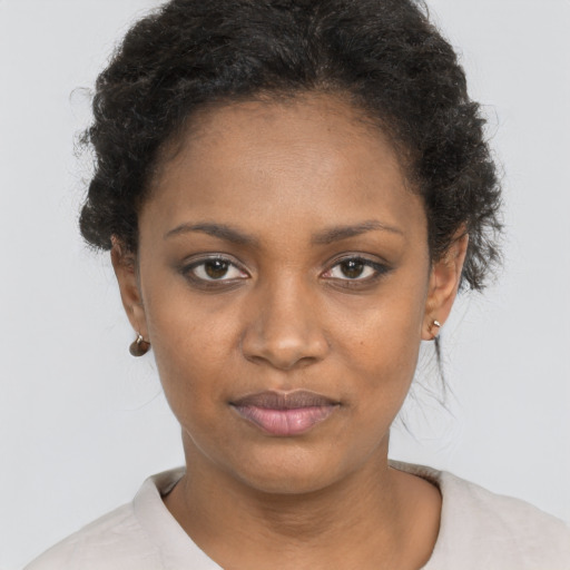 Joyful black young-adult female with short  brown hair and brown eyes