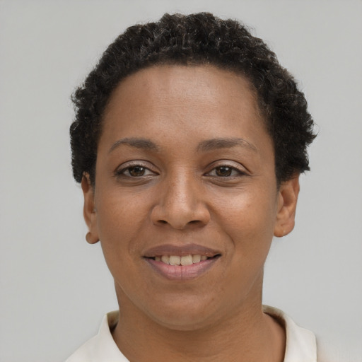 Joyful black young-adult female with short  brown hair and brown eyes
