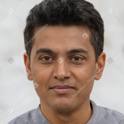 Joyful latino young-adult male with short  brown hair and brown eyes