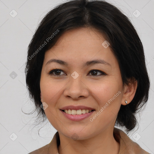 Joyful asian adult female with medium  brown hair and brown eyes