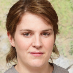 Joyful white young-adult female with medium  brown hair and blue eyes