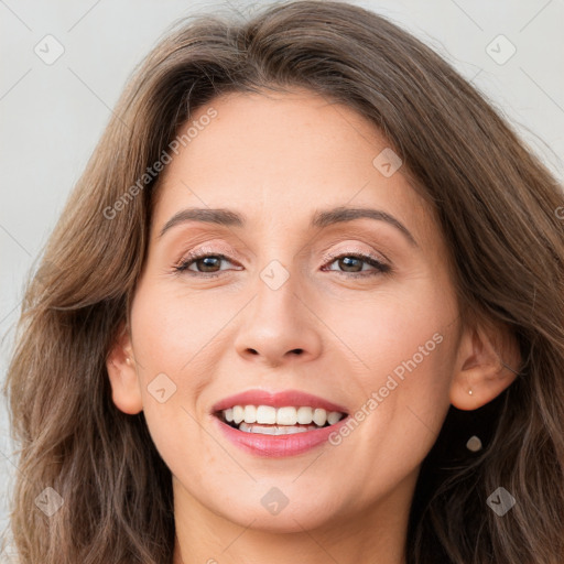 Joyful white young-adult female with long  brown hair and brown eyes