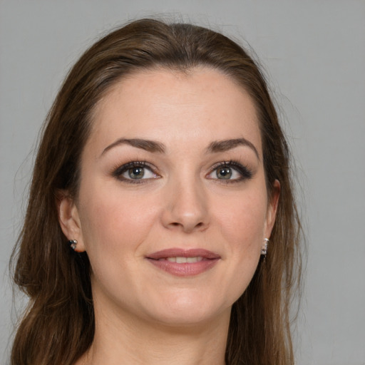 Joyful white young-adult female with long  brown hair and grey eyes