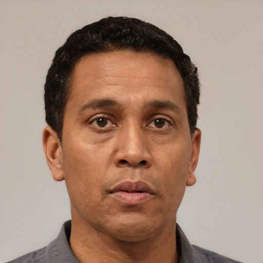 Neutral latino adult male with short  black hair and brown eyes