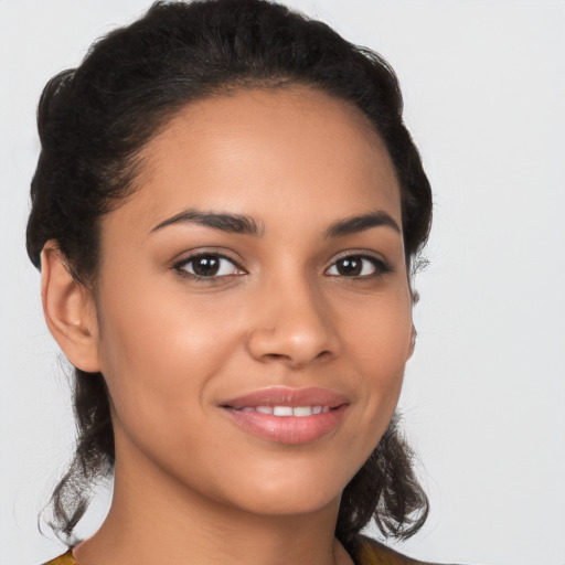 Joyful latino young-adult female with medium  brown hair and brown eyes