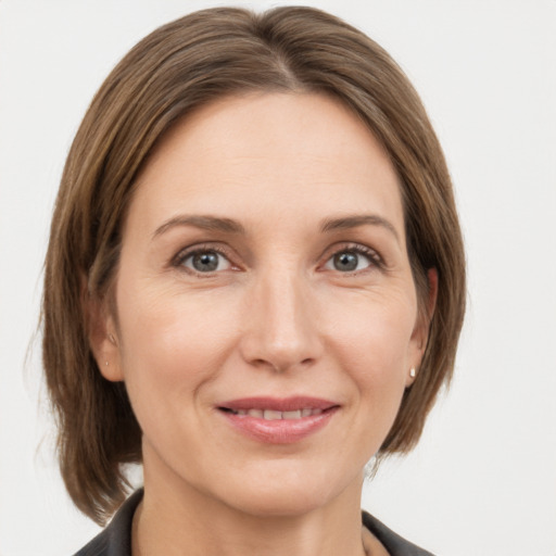 Joyful white adult female with medium  brown hair and grey eyes