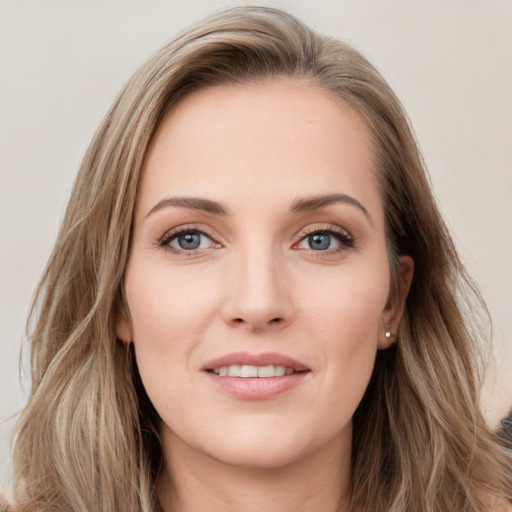 Joyful white young-adult female with long  brown hair and grey eyes