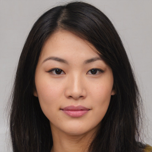 Joyful asian young-adult female with long  black hair and brown eyes