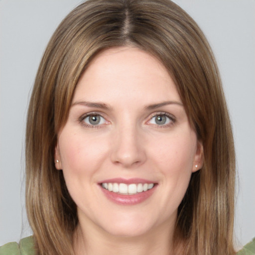 Joyful white young-adult female with medium  brown hair and green eyes