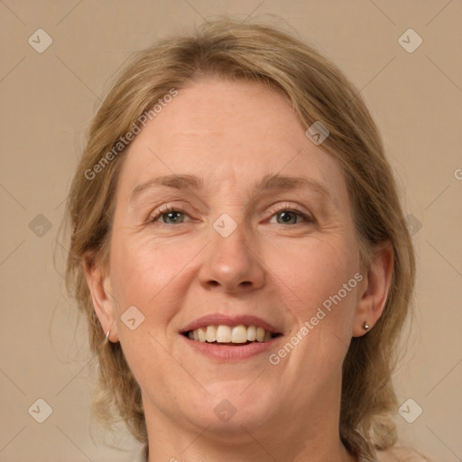 Joyful white adult female with medium  brown hair and grey eyes