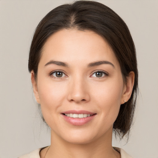 Joyful white young-adult female with medium  brown hair and brown eyes