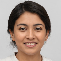 Joyful latino young-adult female with medium  brown hair and brown eyes