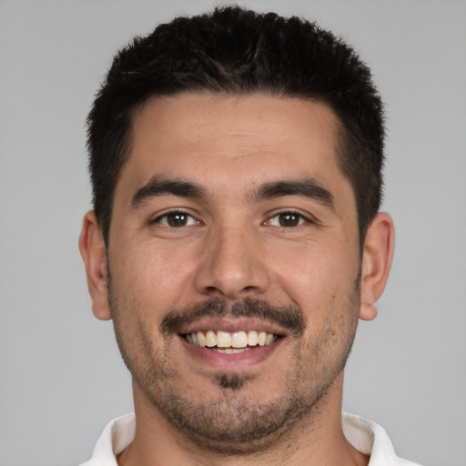 Joyful white young-adult male with short  black hair and brown eyes