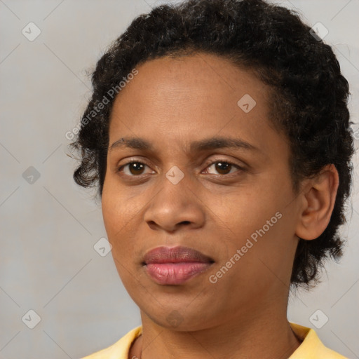 Joyful black young-adult female with short  brown hair and brown eyes