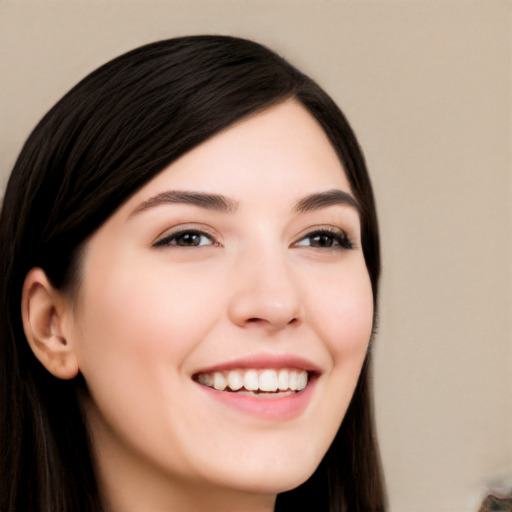 Joyful white young-adult female with long  black hair and brown eyes