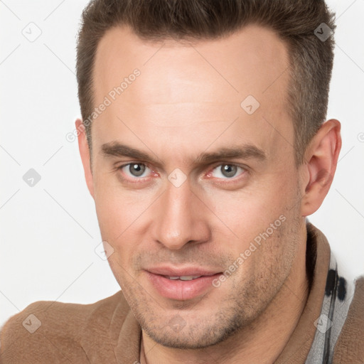 Joyful white adult male with short  brown hair and brown eyes