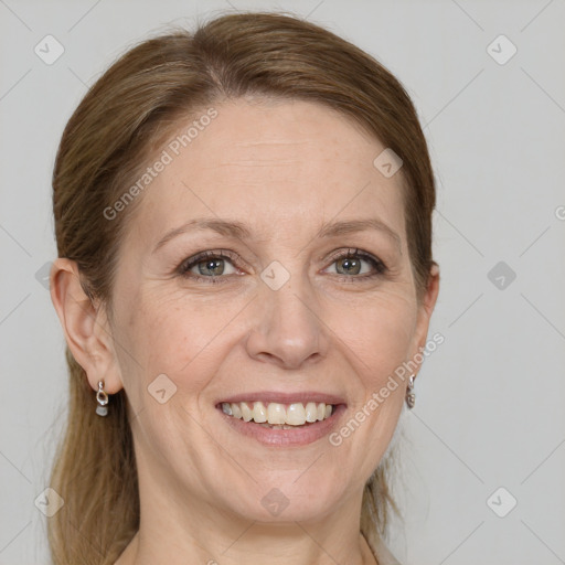 Joyful white adult female with medium  brown hair and grey eyes