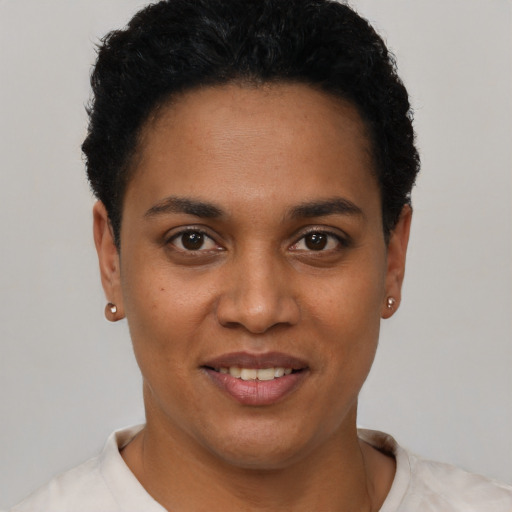 Joyful latino young-adult female with short  black hair and brown eyes