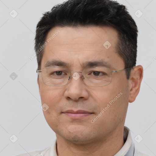 Joyful white adult male with short  black hair and brown eyes