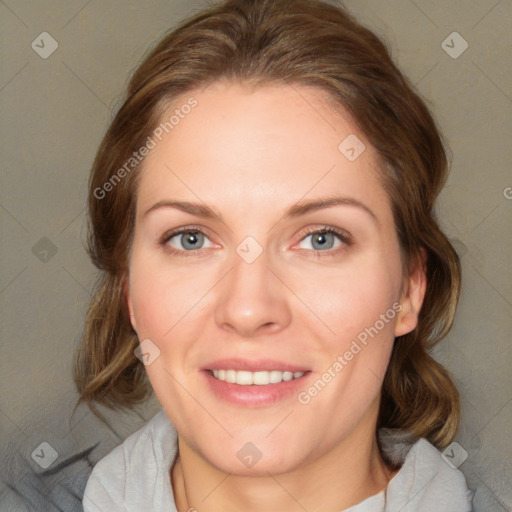 Joyful white adult female with medium  brown hair and blue eyes