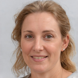 Joyful white adult female with medium  brown hair and blue eyes