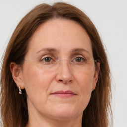 Joyful white adult female with long  brown hair and grey eyes