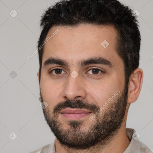 Joyful white young-adult male with short  black hair and brown eyes