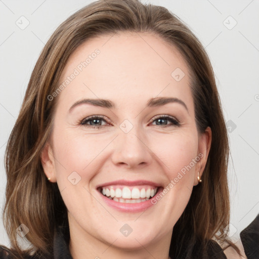 Joyful white young-adult female with long  brown hair and blue eyes