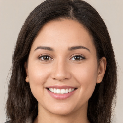 Joyful white young-adult female with long  brown hair and brown eyes